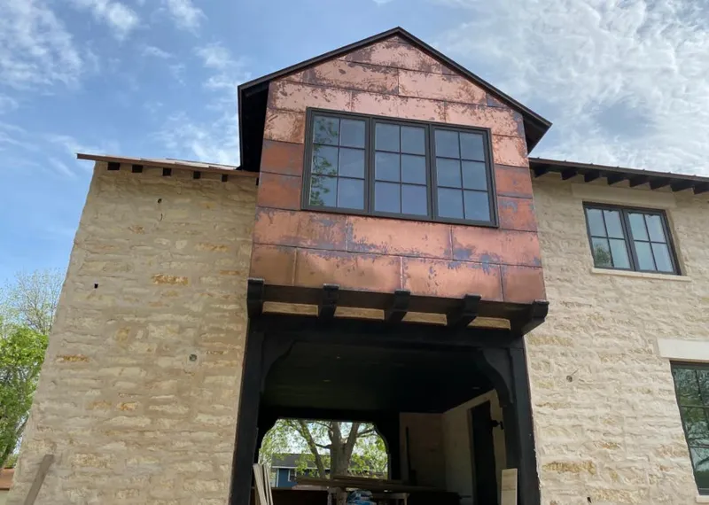 Copper metal panel facade on a stone building for Skylight Installation in Fairmont
